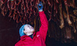 A worker smokes pork products in a meat processing workshop in Yichang, Hubei Province, Ch...