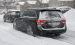 Vehicles drive as a major winter snowstorm hits in Toronto, Ontario, Canada, on January 15...