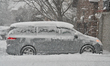 A vehicle is covered in snow as a major winter snowstorm hits in Toronto, Ontario, Canada,...