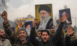 Kashmiri Shiite Muslims shout anti-Israel and anti-U.S. slogans and hold portraits of Iran...