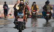 A man dressed as Lord Shiva arrives at the 'Sangam', the confluence of the rivers Ganges,...
