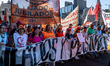 Organized pensioners display banners with slogans against Milei's policies during a new ma...