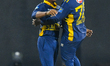 Sri Lanka's Dunith Wellalage celebrates with captain Charith Asalanka after dismissing Eng...