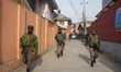 Indian security personnel patrol during a house-to-house search operation as part of heigh...