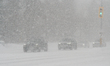Vehicles have difficulty driving during blizzard conditions as a massive snowstorm hits To...