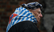 OSWIECIM, POLAND – JANUARY 27:An Auschwitz survivor is seen at the Wall of Death, adjacen...