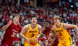 Bobby Durkin #3 of the Minnesota Golden Gophers looks at the hoop while defended by Nolan...