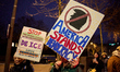 Protesters take part in a rally against ICE and US President Donald Trump's policies in fr...