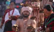 A Nepalese devotee carries oil lamps on his head and shoulders during the Swasthani Brata...