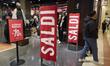 Sale and discount signs are displayed at the entrance of a clothing store inside a shoppin...