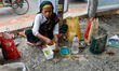 A worker displaced from their home region due to climate change has lunch during their bre...