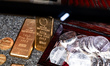 Gold and silver coins and ingots come out of a safe at the Austrian Mint stand during the...