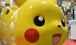 A Japanese girl plays at a Pokemon series character Pikachu-designed vehicle in Tokyo, Jap...