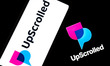 The UpScrolled logo appears on a smartphone screen and as the background on a laptop compu...
