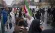 An Iranian woman holds flowers and dances on a street to show her happiness while particip...