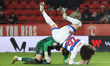 Thomas Kaminski of Charlton Athletic (left) collides with Rayan Kolli of Queens Park Range...