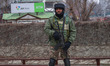 An Indian security personnel stands alert during a random security check in Srinagar, Jamm...