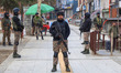 Indian security personnel stand alert during a random security check in Srinagar, Jammu an...