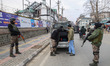 Indian security personnel frisk a vehicle during a random security check in Srinagar, Jamm...