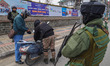 Indian security personnel frisk a motorcyclist during a random security check in Srinagar,...