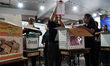 Thai electoral officials count ballots after the polls close in the general election and n...