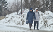 People walk as light snow flurries fall in Richmond Hill, Ontario, Canada, on February 6,...