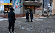 People stand outside a shopping mall damaged by an overnight Russian drone strike in Odesa...
