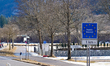 A blue European Union border sign indicates the entry into Austria and stands on the road...