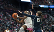 Kelis Fisher #7 of the Connecticut Huskies drives to the rim for a layup against Lily Zein...