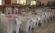Election officials distribute polling materials from a temporary distribution center set u...