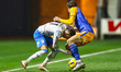 Elliot Newby of Barrow AFC and Tom Sang of Shrewsbury Town battle for the ball during the...