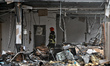 A firefighter works at a car dealership damaged by a Russian drone attack in Odesa, Ukrain...