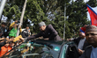 Former Nepali King Gyanendra Bir Bikram Shah greets his supporters as he exits the Tribhuv...