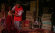 A worker colors incense sticks, often referred to by locals as Hio, in Tangerang Regency,...