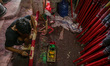 A worker paints incense sticks, often referred to by locals as Hio, in Tangerang Regency,...