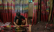 A worker paints incense sticks, often referred to by locals as Hio, in Tangerang Regency,...