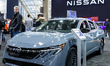 A visitor stands next to a Nissan car during the opening day of the 2026 Canadian Internat...