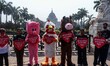 Activists dress in animal costumes and distribute roses to passersby to raise awareness ab...