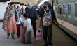 Passengers arrive at Kamalapur Railway Station as people begin returning to the capital fo...