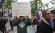 A demonstrator holds up a placard that reads in Arabic ''free political prisoners, free op...