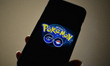 The logo of Pokemon GO is pictured on a smartphone in this photo illustration taken in Tok...