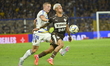 Juan Barinaga, a Boca Jrs player, contests the ball with Juan Gauto, a Platense player, du...