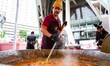 Volunteers cook 500 kilograms of rendang toward a seven-ton target at Taman Ismail Marzuki...