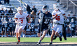 JON KING (11) of the Penn State Nittany Lions drives the ball while ZACH FRIEDMAN (7) of t...