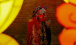 A Chinese artist looks at his phone backstage during the Lantern Festival at Patan Durbar...