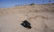 An Iranian man prays near a military tank while visiting the main Iran-Iraq war battlefiel...