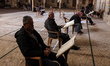 Palestinians read the Koran outside the al-Omari mosque on the first day of the Muslim fas...