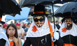 Participants known as 'Los Fiscales' from the Huehues take part in a parade before attendi...