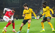 Noni Madueke of Arsenal FC has the ball as he attempts to shake off Hugo Bueno and Mateus...