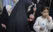 Iranian girls visit the Iranian-Islamic fashion design fair held to commemorate the holy m...
